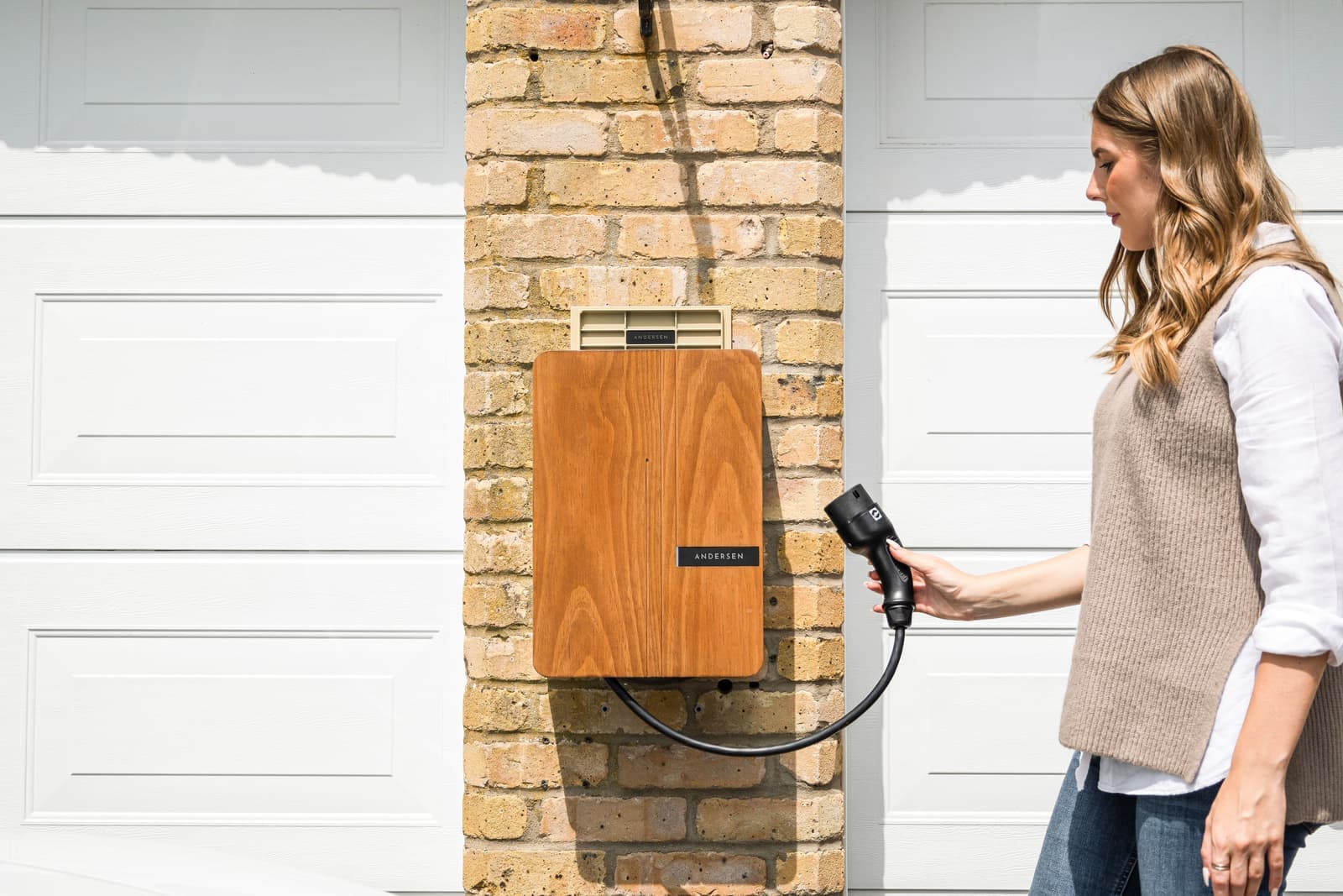 An electric vehicle charging connector plugged into a car's charge port